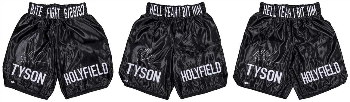 Lot of (3) Mike Tyson Signed "TYSON HOLYFIELD HELL YEAH BIT HIM" Black Boxing Trunks (PSA/DNA)